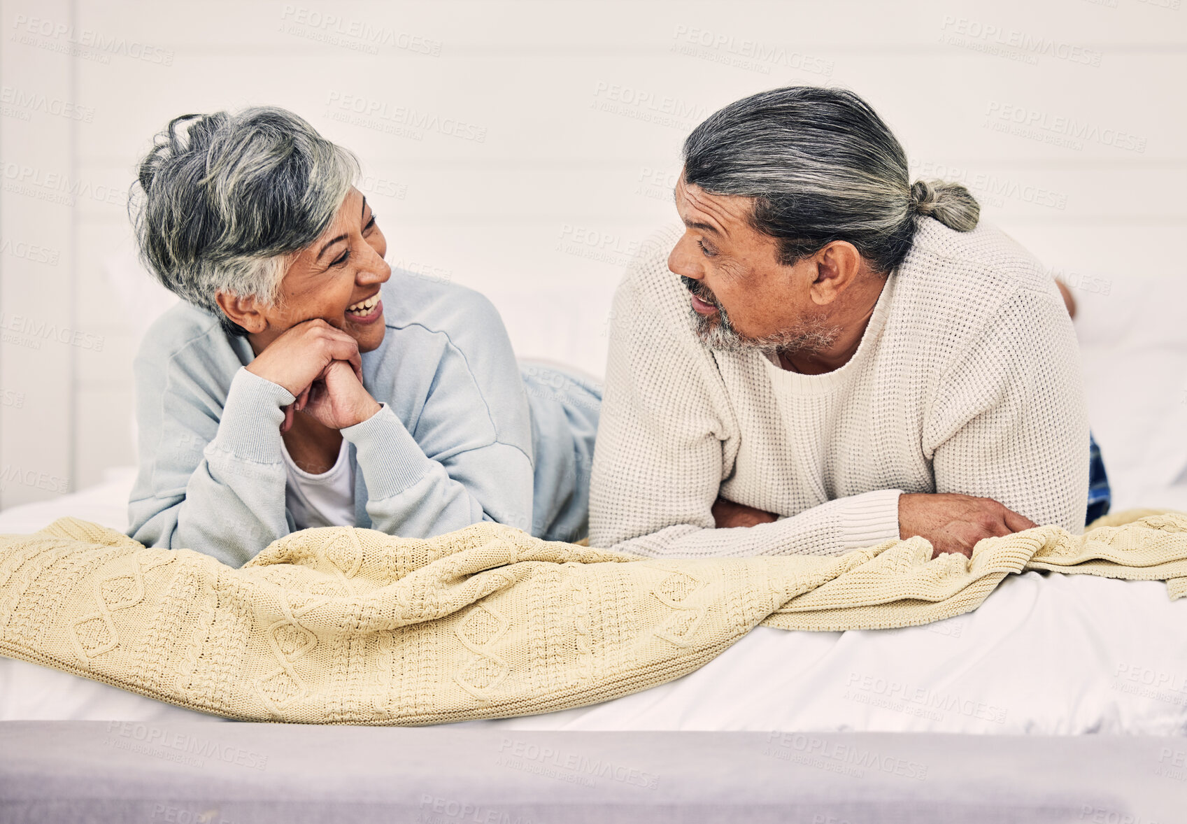 Buy stock photo Happy, talking or old couple in bedroom to relax, enjoy conversation or morning together at home. Speaking, senior woman or funny elderly man laughing or bonding with love or smile in retirement