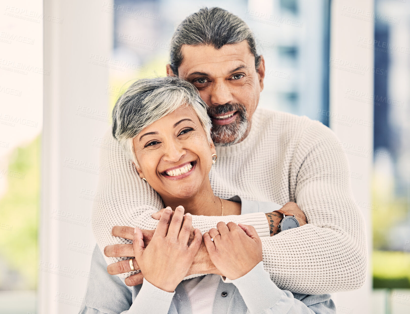Buy stock photo Portrait, happy and senior couple hug in house to relax in retirement together. Face, embrace and elderly man and woman smile for love, care and trust for support, commitment or loyalty in marriage.