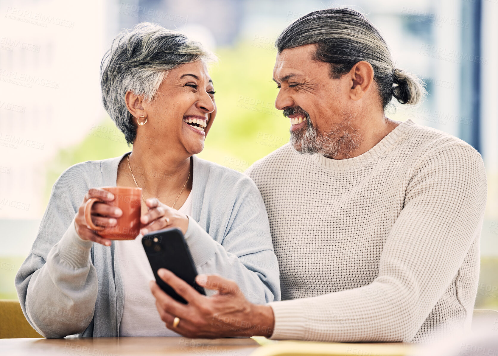 Buy stock photo Senior couple, smartphone and coffee for laugh, comic meme or funny video on web, blog or internet in morning. Mature man, woman and cellphone for social network app, online comedy or bonding in home