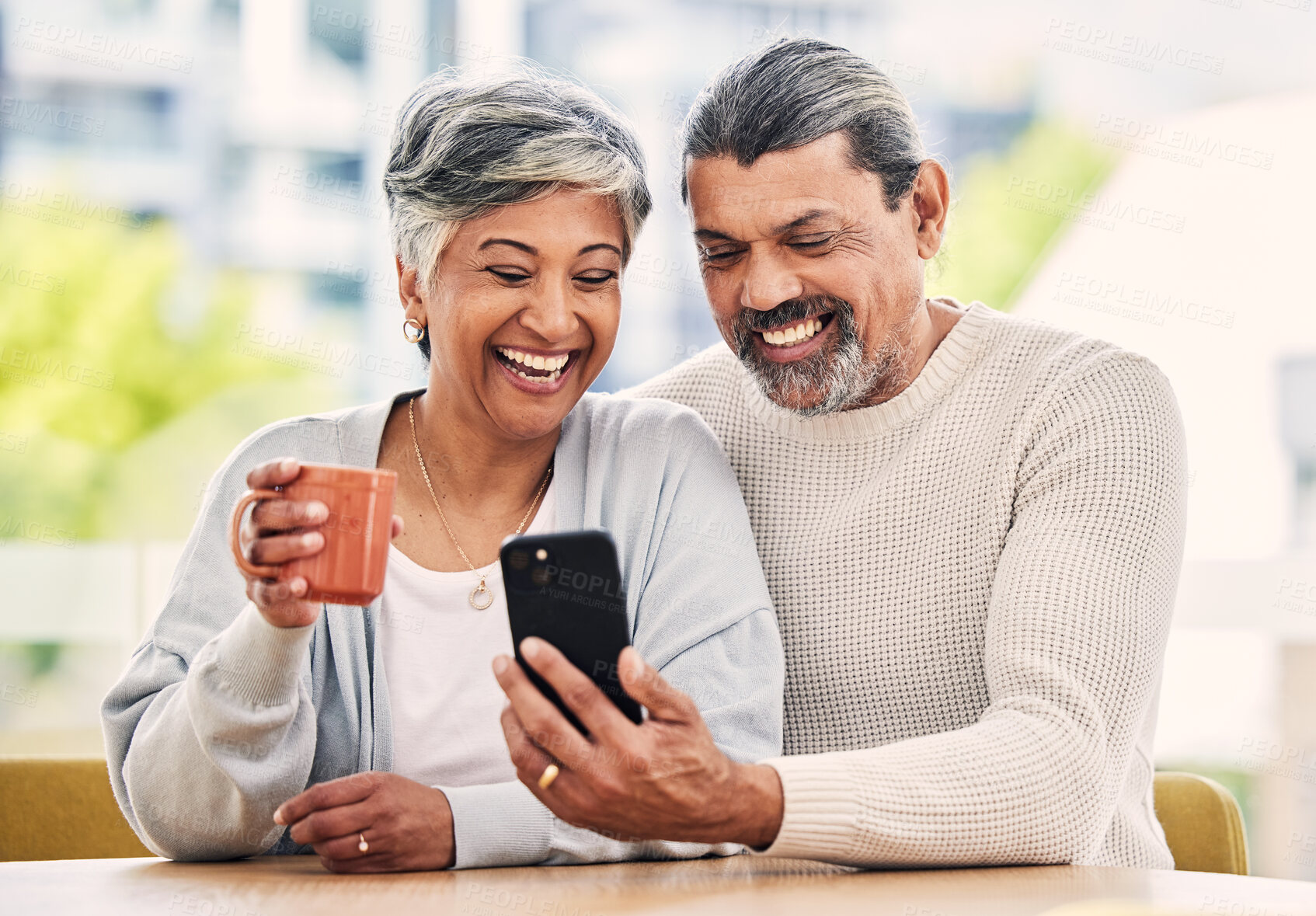 Buy stock photo Senior couple, phone and coffee with laughing, comic meme and funny video on web, blog or internet in morning. Mature man, woman and smartphone with social media app, comedy or video call in house
