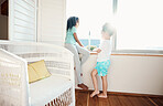 Window, bedroom and children in home in morning looking outdoors for relax, playing and quality time. Family, childhood and young kids in apartment with scenic view for bonding, calm and reflection