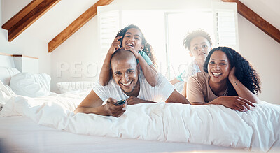 Buy stock photo Funny, family portrait and watching tv in bedroom, bonding and sunshine with lens flare. Face, television and children with father, mother and happy parents relax in home, streaming movie and laugh.