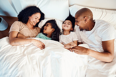 Buy stock photo Top view, bed and family with love, laughing and funny happiness, bonding and loving together. Parents, mother or father with children, kids and cheerful in a bedroom, humor and quality time with joy