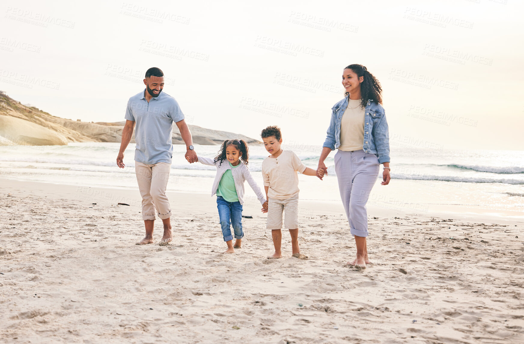 Buy stock photo Beach, holiday and happy family holding hands, walking and bond in nature together. Love, children and parents at the sea for travel, freedom and adventure at the ocean, relax and having fun on trip