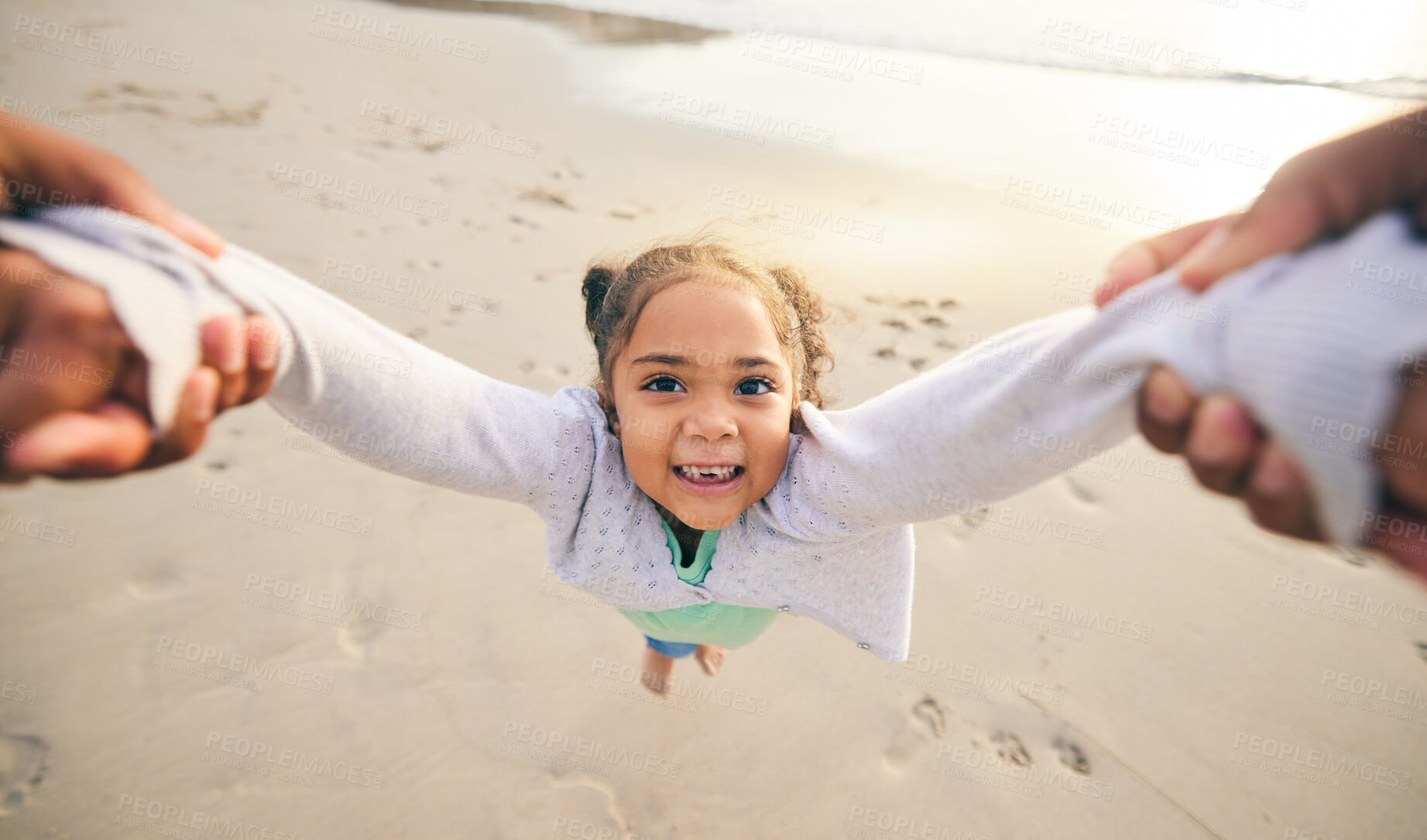 Buy stock photo Happy, swinging and portrait of child at the beach for travel, support and fun. Spinning, smile and summer with girl and holding hands with family together for vacation, trust and seaside holiday