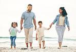 Happy family, holding hands and walking at a beach for travel, vacation and fun in nature together. Freedom, parents and children relax at the sea on holiday, trip or adventure on ocean walk in Bali