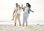 Beach, family and holding hands outdoor for travel, freedom and bond in nature together. Love, fun and boy child with young parents at the sea with swing game, playing and happy on ocean holiday trip