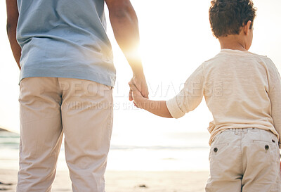 Buy stock photo Back, beach and a father holding hands with his son as a family at sunset by the ocean or sea together. Children, love and a boy with his dad on a coast in nature while on summer vacation or holiday