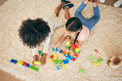 Buy stock photo Relax, play and above of children on floor with building blocks for learning, education and child development. Family, home and top view of girls in living room with toys for fun, creativity or games