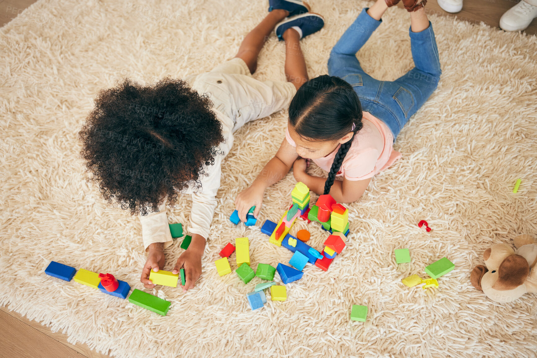 Buy stock photo Relax, play and above of children on floor with building blocks for learning, education and child development. Family, home and top view of girls in living room with toys for fun, creativity or games