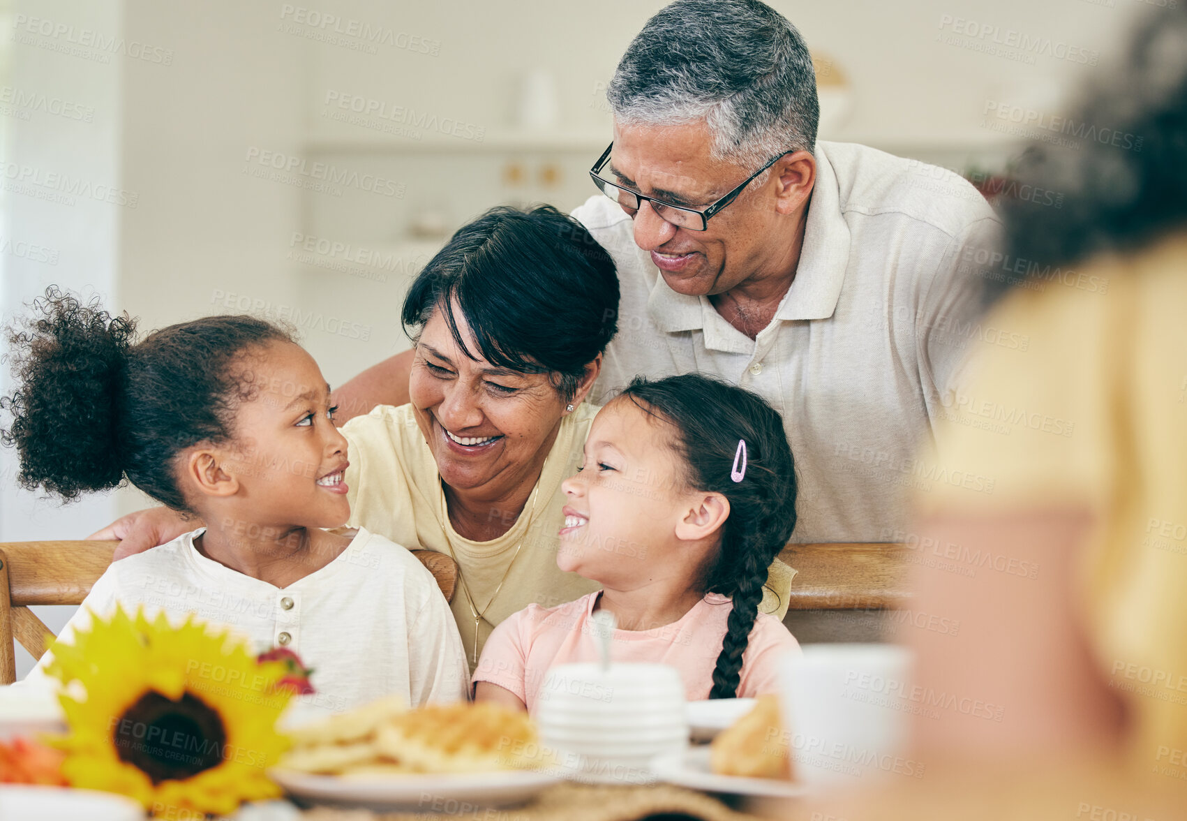 Buy stock photo Happy, grandparents and children at table for lunch, dinner and meal together for celebration at home. Family, party and grandpa, grandmother and kids with food for bonding, gathering and holiday
