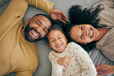 Buy stock photo Happy family, above and kid smile or happy with parents together in the morning laughing in a bedroom on a bed. Relax, mom and dad enjoy quality time with kid with happiness, bonding and love