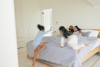 Buy stock photo Wake up, happy family and playing in bed in the morning, bond and having fun in their home together. Love, bedroom and children jumping on parents on the weekend, playful and energetic in their house