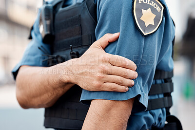 Buy stock photo Man, police and arm injury in city from accident, gun shot or pain in discomfort outdoors. Closeup of male person, officer or security guard with painful joint, inflammation or wound in an urban town