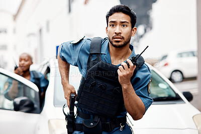 Buy stock photo Asian man, police and walkie talkie with gun in city for suspect, communication or reinforcements. Serious male person, security guard or cop radio calling backup for crime in street of an urban town