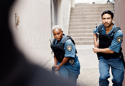 Buy stock photo Police, crime and team in the city for protection, justice and law enforcement mission. Serious, collaboration and young woman and man security officers working with guns together in an urban town.
