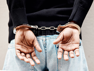 Buy stock photo Man, handcuffs and criminal in arrest for crime, justice or theft against the wall of suspect. Closeup of male person, gangster or thief in corruption, violence or fraud for jail, prison or locked up