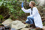 Forest, research and woman environmentalist test water sample for inspection of the ecosystem and environment study. Science, sustainable and professional scientist doing carbon footprint exam