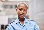 Portrait, woman and security guard in city for surveillance service, safety and patrol. Law enforcement, bodyguard or face of black female police officer in blue shirt for crime watch in urban street