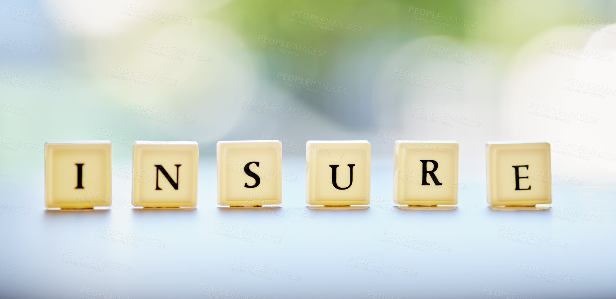 Buy stock photo Letters, blocks and an insurance message on a desk for business, security or finance with bokeh. banner, mockup and a word on a table at a financial company for profit, investment or savings