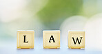 Law letter, and table with block cubes in outdoor blur with mock up space for business or customer. Frequently, asked and questions for support or service in nature background with regulation.