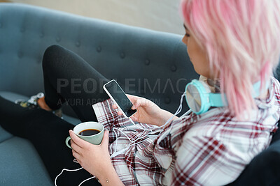 Buy stock photo Relax, coffee and a woman with a phone for music, social media or communication on the sofa. Contact, tech and a punk girl with a drink and a mobile for streaming a podcast or audio on the couch