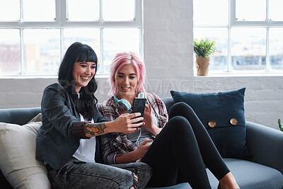Buy stock photo Phone, social media and students with women friends sitting on a sofa in the campus breakroom at college. Education, university and young female pupils reading a text message while on break to relax