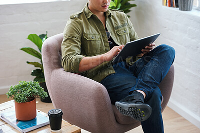 Buy stock photo Working from home, man with chair and tablet, relax in living room with internet search and coffee. Networking, reading website and freelancer with digital app for remote work in social media job.