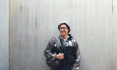 Buy stock photo Fashion, student and gen z asian male happy, confident and 
 with cool clothes on wall background, smile and chilling. Travel, fashionable and Japanese guy outdoors casual, contemporary and stylish