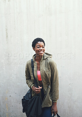 Buy stock photo Education, thinking and smile with a woman student leaning against a gray wall on the campus of her university. Scholarship, idea and future with a happy young female pupil learning at college