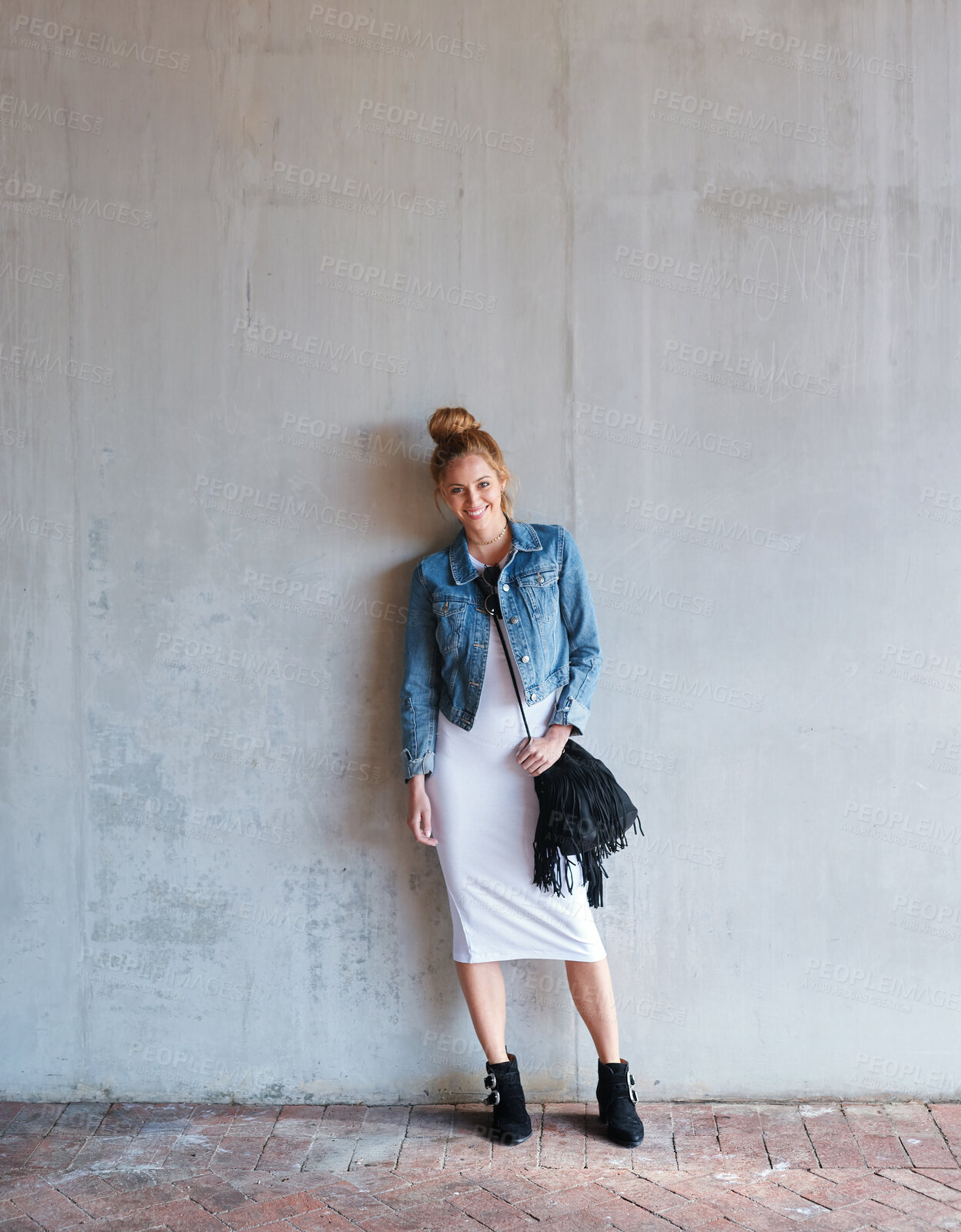 Buy stock photo Portrait, travel and smile with a woman on a concrete wall as a tourist leaning against a building in the city. Fashion, tourism or travelling with a happy and trendy young person in Norway for style