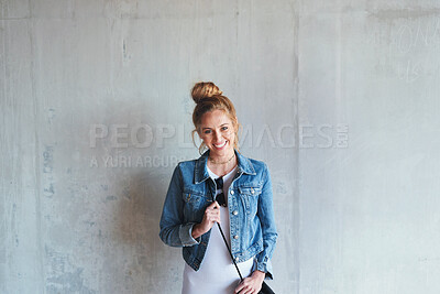 Buy stock photo Portrait, education and happy with a woman student leaning against a gray wall on the campus of her university. Smile, study and scholarship with a young female pupil standing at college for learning
