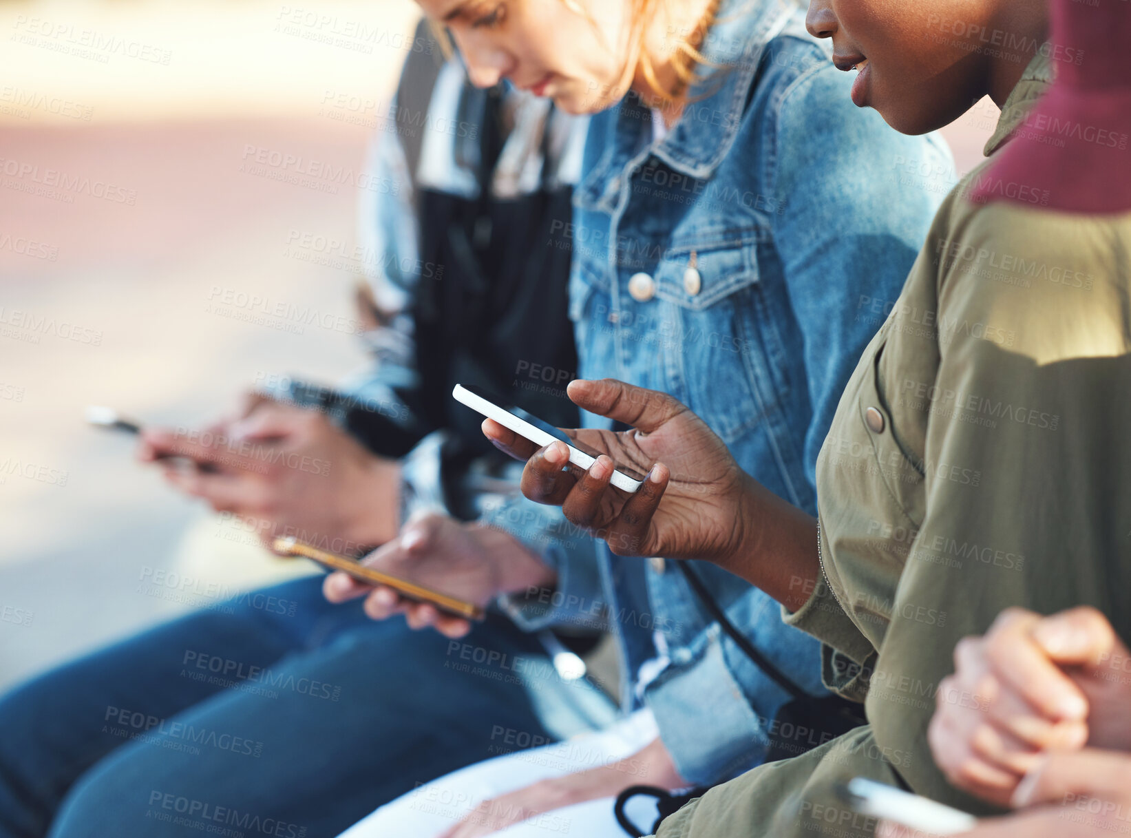 Buy stock photo Friends, smartphone and students outdoor, college and social media, reading chat online and connectivity. Young people at campus, using phone and check mobile app, technology and communication