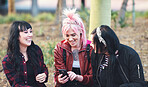 friends in city hanging out college students laughing having fun with punk girl using smartphone in city