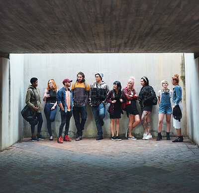 Buy stock photo People, student and friends in relax or social gather standing against a wall in urban town. Diversity or group of creative teenagers hanging out together on college campus with mockup space outside
