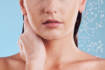 Buy stock photo Woman, hands and shower in water for hygiene, cleaning or self love and body care against a blue studio background. Closeup of female person in skincare, rain or wash for cleanliness or grooming