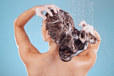 Buy stock photo Woman, back and shampoo, haircare  in shower and hygiene with water drops on blue background. Grooming, cosmetic care and sustainability, female person and morning routine, soap or foam in hair