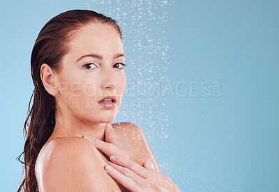 Buy stock photo Shower, portrait and skincare with cleaning and woman in studio or blue background for wellness. Girl, cosmetics and water with beauty routine for hygiene or self love with dermatology in bathroom