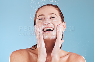 Buy stock photo Woman, cleaning face and soap with beauty, shower and hygiene with grooming isolated on blue background. Female model, sustainability and water drop with happiness, dermatology and skincare in studio