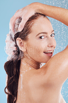 Buy stock photo Woman, washing hair with shampoo in shower, portrait and hygiene with water drops on blue background. Grooming, cosmetic care and sustainability, female person and morning routine, soap and haircare