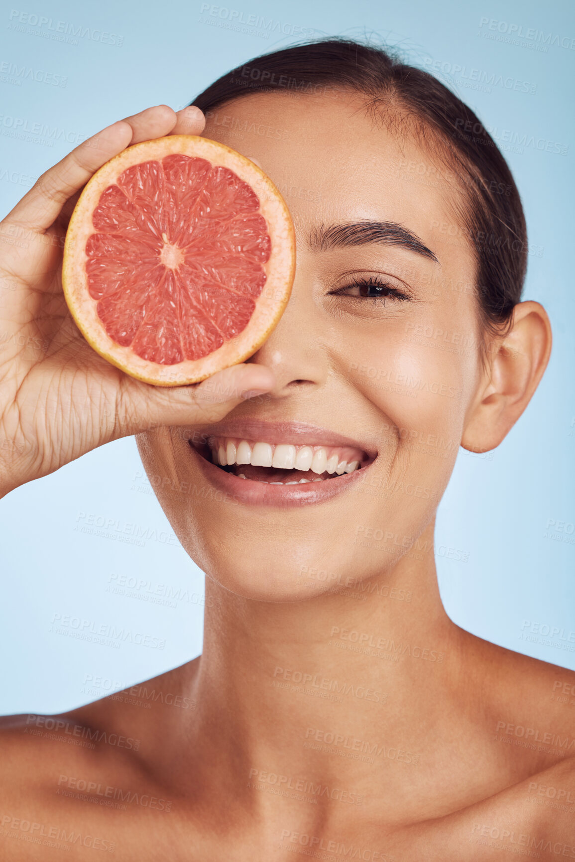 Buy stock photo Face, skincare and natural woman with grapefruit in studio isolated on a blue background. Fruit, portrait smile and happy model with food for nutrition, healthy vegan diet or vitamin c for wellness