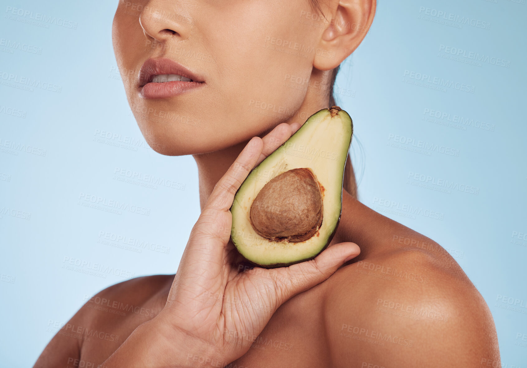 Buy stock photo Skincare, beauty and woman with avocado, natural makeup and facial detox on blue background. Health, wellness and closeup of model, organic luxury cleaning and cosmetics with fruit in hand in studio.