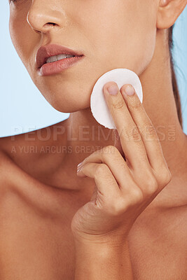 Buy stock photo Woman, hands and cotton pad for skincare, makeup removal or cosmetics against a blue studio background. Closeup of female person with round swab or patch for cleaning, hygiene or facial spa treatment