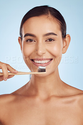 Brushing teeth, portrait and woman with dental, hygiene and grooming with oral care isolated on blue background. Female model cleaning mouth, health and morning routine and toothbrush with toothpaste