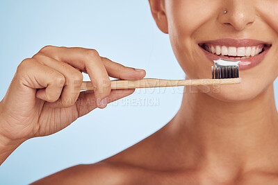 Happy woman, hands and toothbrush for dental care, health and wellness against a blue studio background. Closeup of person smile with brush for cleaning teeth, oral mouth and gum hygiene in self love