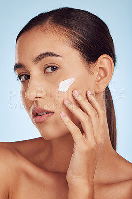 Buy stock photo Cream on face, beauty and woman with skincare, cosmetic product isolated on blue background. Portrait, moisturizer and lotion for skin, sunscreen and dermatology, female person and anti aging facial