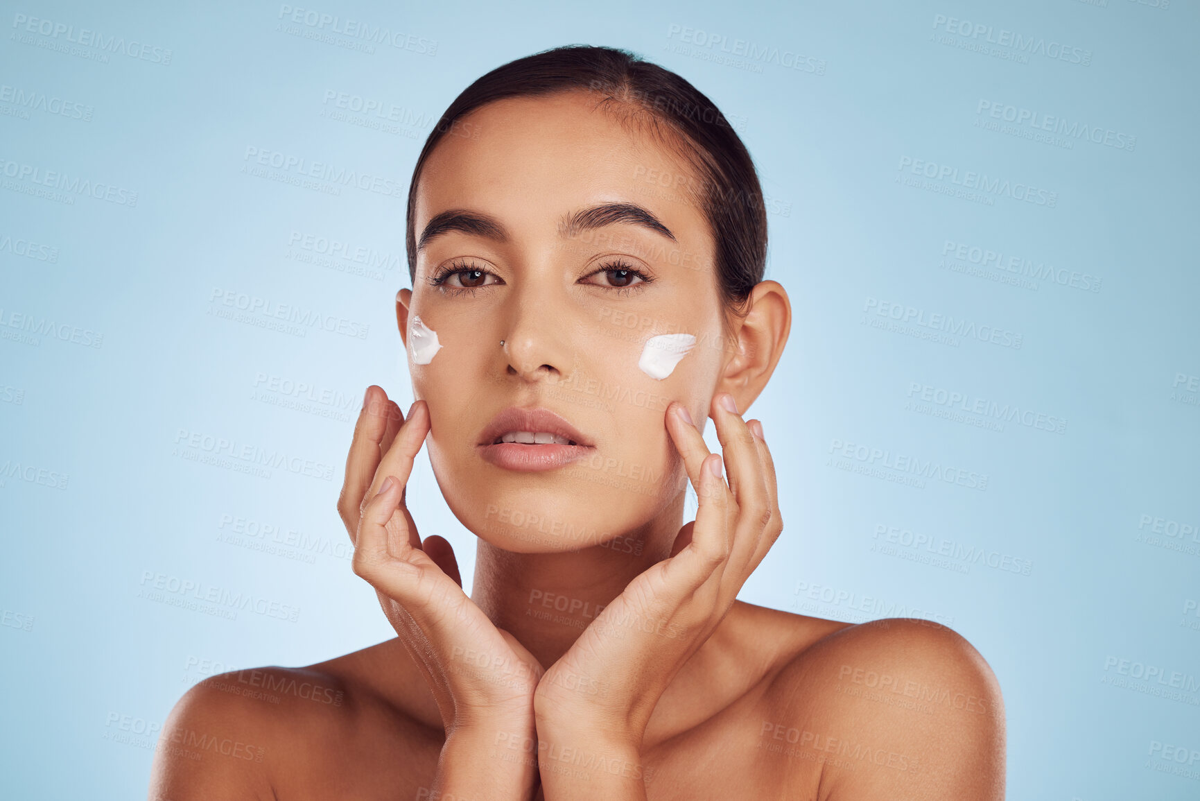 Buy stock photo Portrait, beauty and woman with cream, dermatology and skincare on a blue studio background. Face, female person and model with lotion, cosmetics and grooming with creme, aesthetic and luxury product