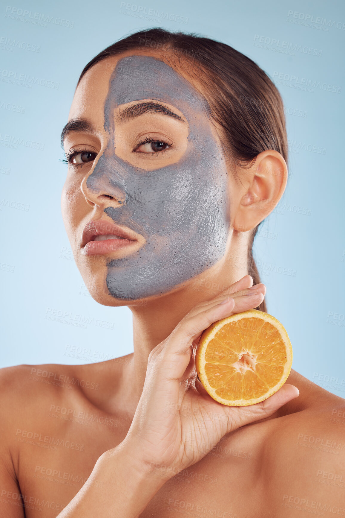 Buy stock photo Portrait, face mask and orange with beauty and skincare, eco friendly product and cosmetic on blue background. Charcoal facial, citrus fruit and vitamin c, female model has skin detox and dermatology