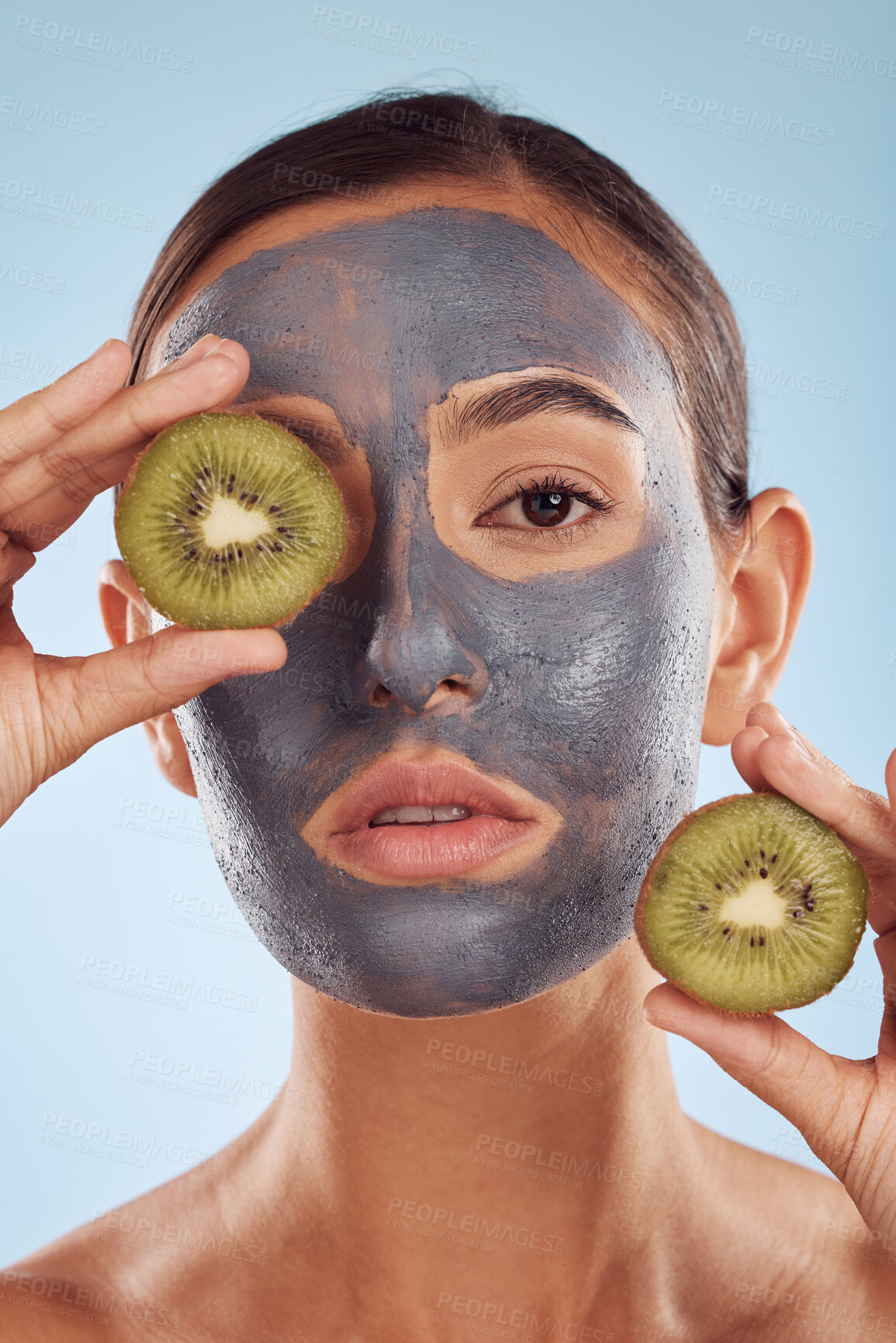 Buy stock photo Portrait, face mask and kiwi with beauty and woman, skincare and eco friendly product on blue background. Charcoal facial, fruit and vegan treatment, female model with skin detox and dermatology