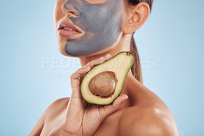 Buy stock photo Woman, avocado and face mask for skincare, natural beauty and vitamin d benefits on studio, blue background. Person or model with charcoal facial, green fruits and healthy skin care for dermatology